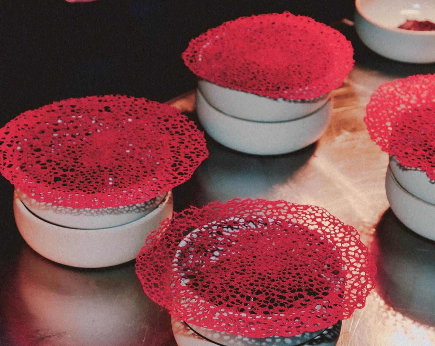 Red culinary compositions from Clara Rupp Dining, shown as a reference for the developing collaboration.